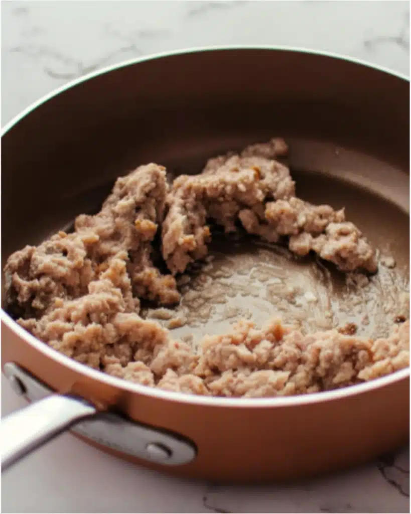 Breakfast Grilled Cheese (Easy, Cheesy & Satisfying Morning Sandwich) 2 Raw breakfast sausage in skillet ready to cook