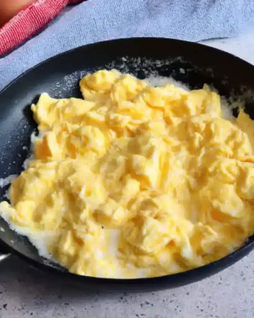 Soft-scrambled eggs in a nonstick skillet for breakfast burrito filling