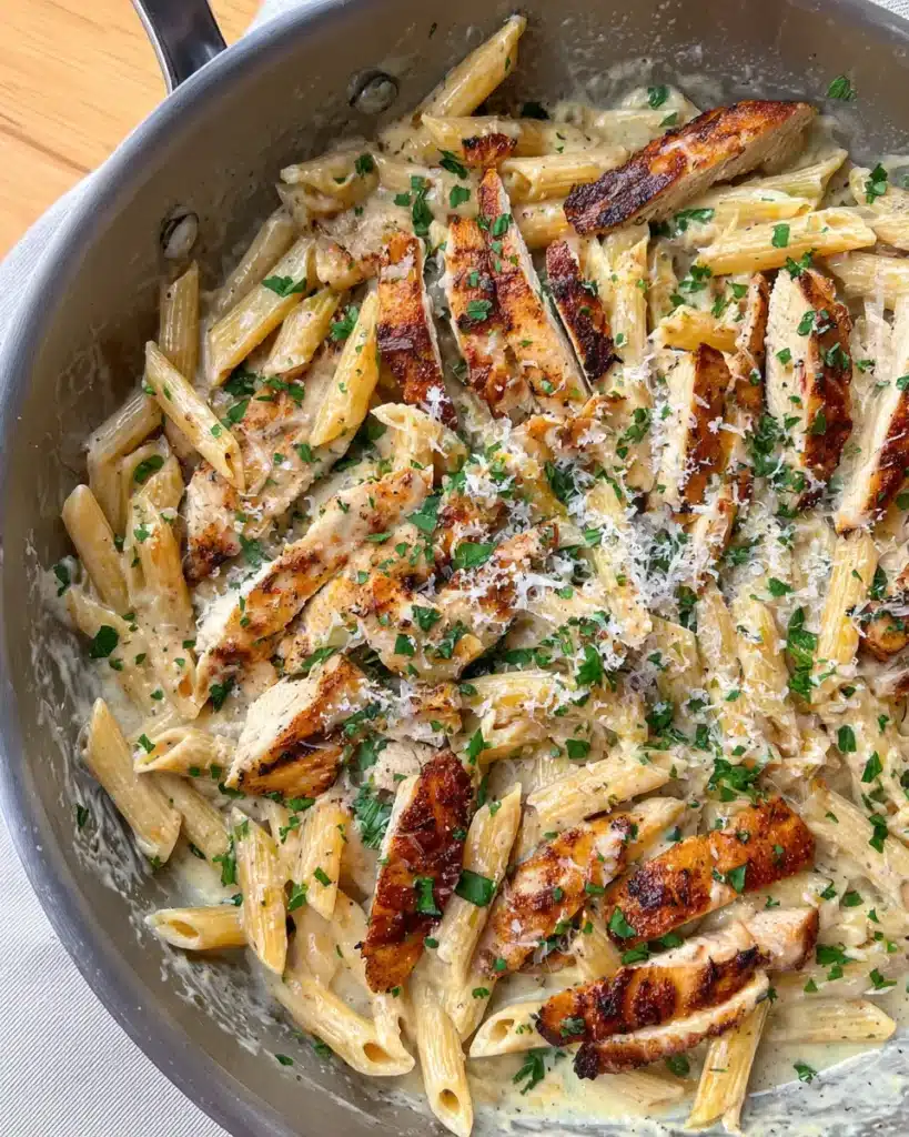 Creamy Garlic Parmesan Chicken Pasta 4 Creamy garlic parmesan chicken pasta in skillet with parsley and parmesan
